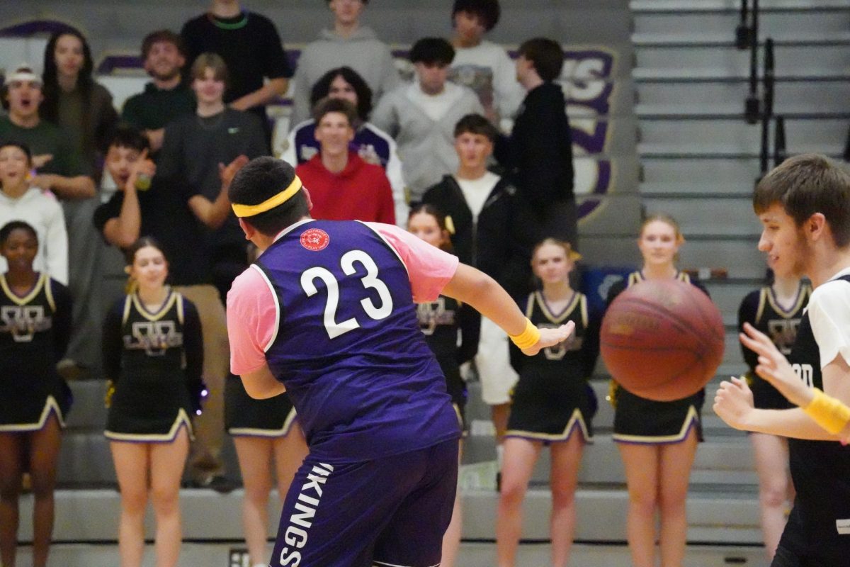 Junior Ben Nye celebrates a shot with the Lake Stevens student section. 