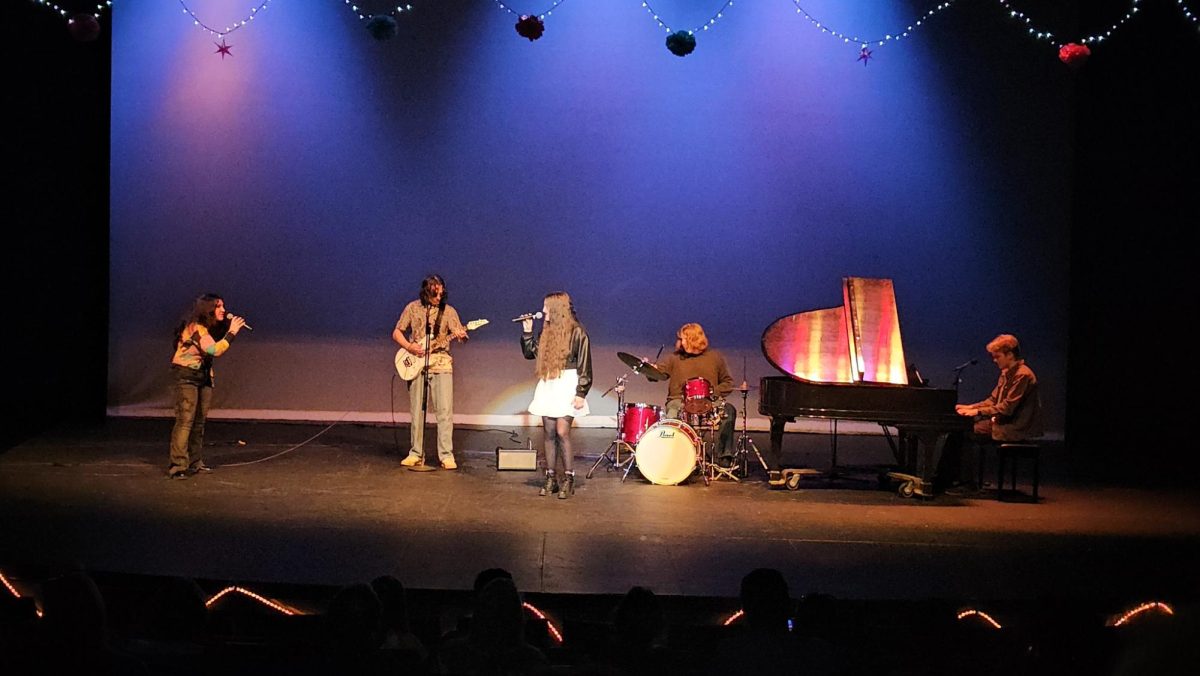 Graduates Annslea Bixler and Hailey Curtis, senior Jackson Woll, and guest alumni Tanner Woll and Alex Kleparek “Bring Me To Life” by Evanescence.
