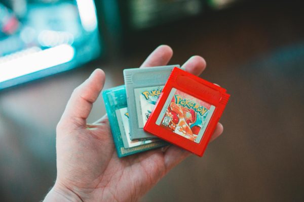 A person holding early Pokémon games, showing how far the franchise has come.