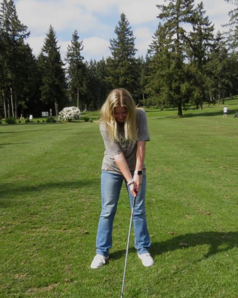 Senior Kaitlyn Thompson practices her golf swing at Battle Creek Golf Course on May 5, 2026.